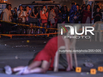 The body of Cristita Padual is slumped on a chair after she was shot dead by unknown assailants in Quezon city, north of Manila, Philippines...
