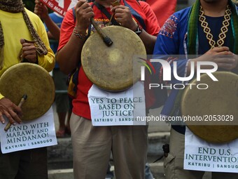 Different labor groups mark the first year of President Duterte’s administration with protests as they march near the Malacanang Palace in M...