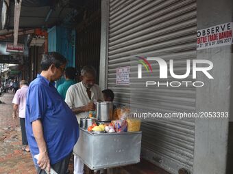A Daily vendor sales in front of closed shop at Burrabazar during the daylong nationwide strike, demanding changes in the GST regime in Kolk...