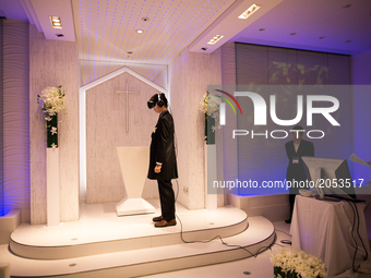 TOKYO, JAPAN - JUNE 30: Anime fan marry his VR (Virtual Reality) anime girl crush in front of an altar of a chapel in Tokyo, Japan on June 3...