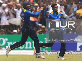 Sri Lankan cricketer Wanidu Hasaranga(R) celebrates after he completed taking a  hat-trick of wickets against Zimbabwe during the 2nd One Da...