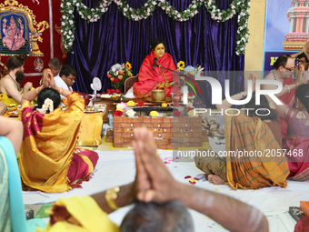 Devotees of Her Holiness Amma Sri Karunamayi performs special prayers during the Homa (sacred fire ceremony) at the Bhuvaneswari Amman Templ...