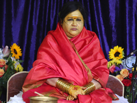 Her Holiness Amma Sri Karunamayi performs special prayers during the Homa (sacred fire ceremony) at the Bhuvaneswari Amman Temple in Brampto...