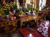 A woman prays at the temple of DEN NGOC SON (tortoise temple) in the city of Hanoi, Vietnam, on 5 June 2017. Hanoi, is the capital of the De...