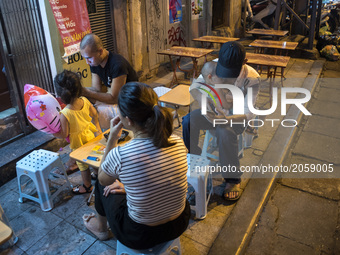 A Vietnamese family is watching their smartphone on a street in Hanoi, Vietnam, on 5 June 2017. Hanoi, is the capital of the Democratic Repu...