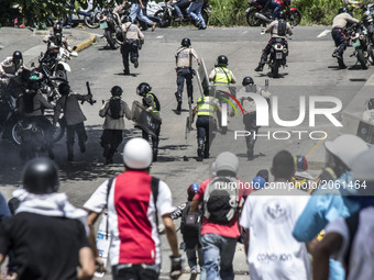 Demonstrators make the National Police run to scape during a rally, in Caracas, Venezuela, 04 July 2017. The called 