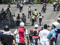 Demonstrators make the National Police run to scape during a rally, in Caracas, Venezuela, 04 July 2017. The called 