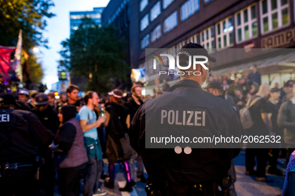 A policeman observes the demonstration. About 20000 people demonstrated in a march with several music cars against the G20 summit. At the G2...