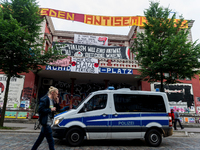 A police car passes by the autonomous center Rote Flora in the district Schanzenviertel. About 20000 people demonstrated in a march with sev...