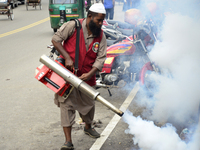 An employee of Dhaka North City Corporation sprays pesticide for kill mosquitoes at Tejgaon in Dhaka, Bangladesh on July 06, 2017. (