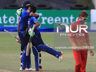 Sri Lankan cricketers Danushka Gunathilaka and Nirosha Dickwella embrace eachother after Danushka Gunathilaka scored a century  against Zimb...