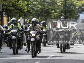 Members of the national police ride their motorcyles ad they shot tear gas bombs, in Caracas, Venezuela on July 6 2017. (