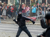 A demonstrator throws a stone towards the police, in Hamburg, Germany, on July 7, 2017. In the evening there was a lot of riots in the Schan...