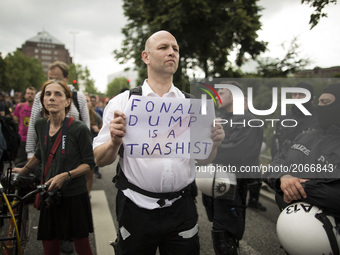 Germany, Hamburg: A man shows a placard against Donald Trump during the 'Hamburg Shows Attitude' demonstration in Hamburg, Germany,  on July...