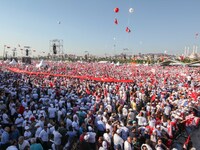 Thousands of supporters cheer and wave flags while listening to Turkey's main opposition Republican People's Party (CHP) leader Kemal Kilicd...