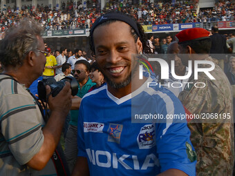 Former player of FC Barcelona Brazilian Ronaldinho (C) arrives for friendly match with Pakistani football players on July 9, 2017 in Lahore....