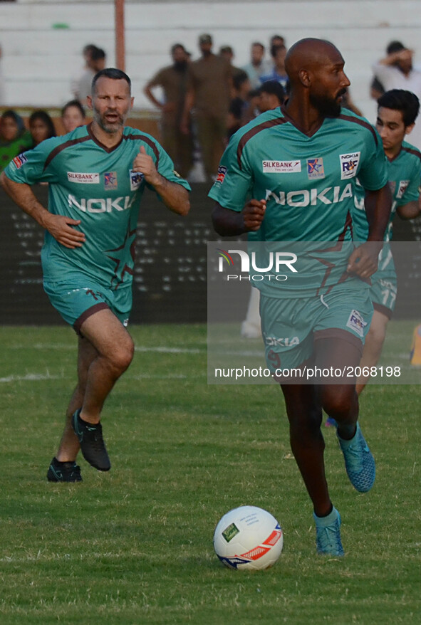 Former French players Nicolas Anelka (R)Former english player Ryan Giggs (C) during friendly match with Pakistani football players,July 9, 2...