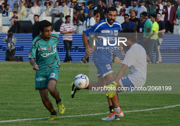 Former French players Robert Pires ( R) play with pakistan football player during friendly match,July 9, 2017 in Lahore. Eight of football's...
