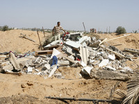 A Palestinians inspect the rubble of a destroyed home following an earlier Israeli air strike in Rafah in the southern Gaza Strip, on August...