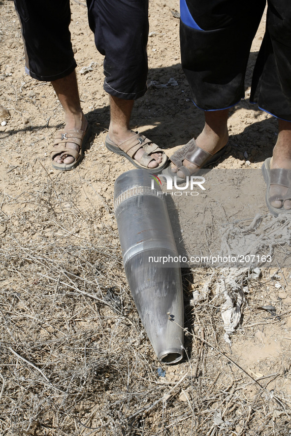 Palestinians look at the Projectile fired from an Israeli fly earlier in Rafah in the southern Gaza Strip, on August 6, 2014, while Israeli...