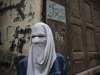 A Kashmiri masked protestor looks upon during funeral of a local rebel Sajad Gilkar Wednesday, July 12, 2017 in Srinagar, Indian-administere...