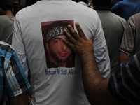 A kashmiri protester wearing a shirt with a poster of Burhan wani Top rebel leader killed last year  takes part in the funeral procession of...