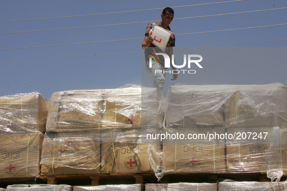 A Palestinian checks a truck loaded with humanitarian aid as it arrives in the Palestinian town of Rafah through the Kerem Shalom crossing b...