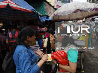 Indian women lunch brake at a street food stall at the Asia biggest wholesale market  Barabazar area on July 14,2017 in Kolkata, India.  (