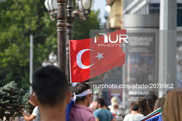 A Turkish flag waves as a man sells flags on the street in Ankara, Turkey on July 14, 2017. On July 15, 2016, Turkish military factions, whi...