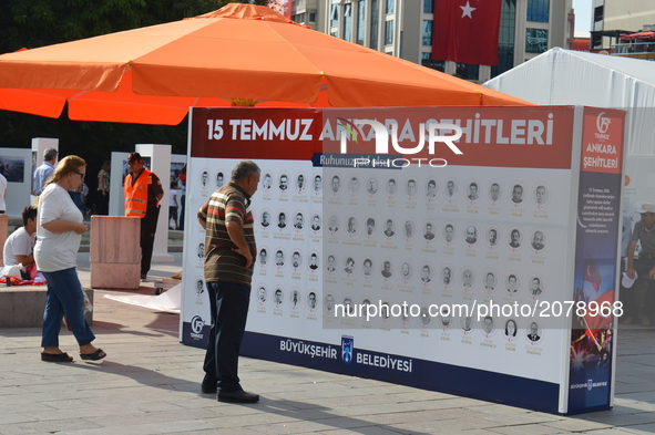 People look at a board with the names of victims marking the 1st anniversary of Turkey's failed coup attempt in Ankara, Turkey on July 14, 2...