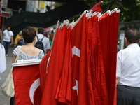 A person walks with Turkish flags on the street in Ankara, Turkey on July 14, 2017. On July 15, 2016, Turkish military factions, which organ...