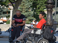 Two men in their wheelchairs are seen outside the Haci Bayram Veli Mosque in Ankara, Turkey on July 14, 2017. On July 15, 2016, Turkish mili...