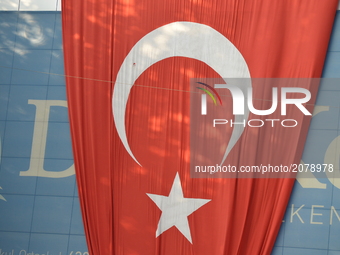 A giant Turkish flag is seen on the wall of a building marking the 1st anniversary of Turkey's failed coup attempt in Ankara, Turkey on July...