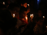 Palestinian children hold candles during a protest against the blockade on Gaza Strip in Gaza City on July 14, 2017. The United Nations warn...
