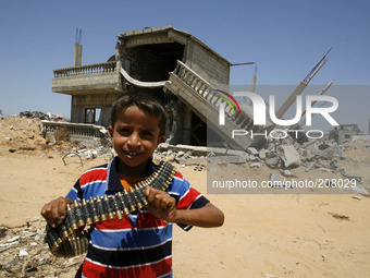 A Palestinian boy holds a bullet belt, who left empty by the Israeli army earlier entry of specific regions inhabited by people close to the...