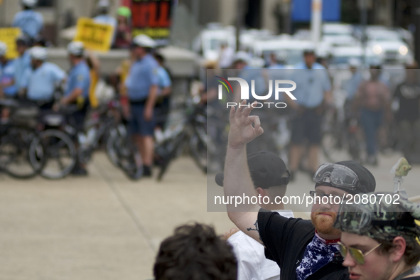 A Trump supporter is seen making a gesture on the sidelines of an Anti-Trump Refuse Racism rally in Center City Philadelphia, Pennsylvania,...