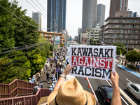 Anti-racist holds a banner during a counter-protest rally against 