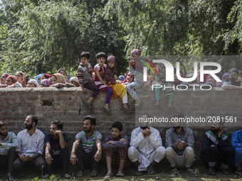 Kashmiri villagers including children watch the funeral procession of a local rebel Parvaiz Mir during his funeral, Sunday, July 16, 2017, i...