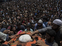 Kashmiri villagers touch the body of a local rebel Parvaiz Mir during his funeral procession, Sunday, July 16, 2017, in Pohoo village 38 kil...