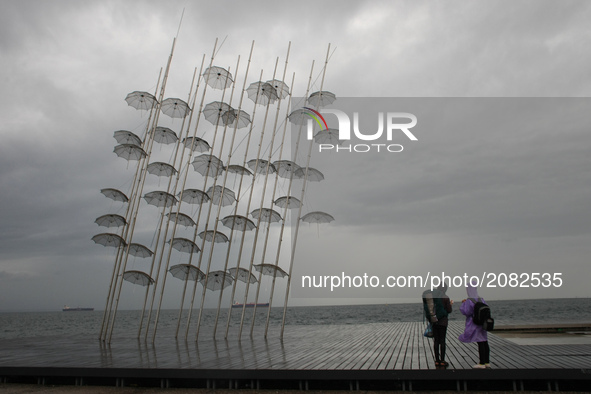 People walks in Thessaloniki, Greece, on July 17, 2017 during a rainy day. 