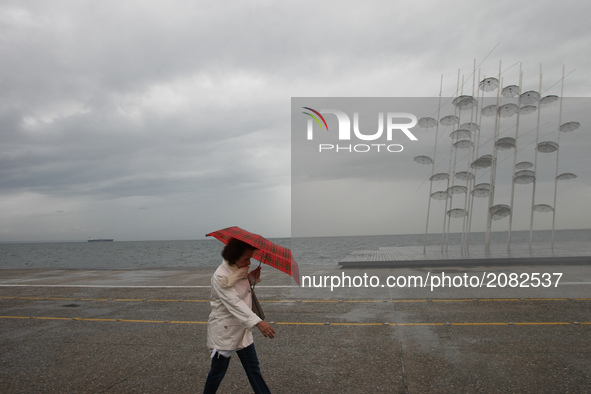 People walks in Thessaloniki, Greece, on July 17, 2017 during a rainy day. 