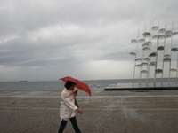 People walks in Thessaloniki, Greece, on July 17, 2017 during a rainy day. (