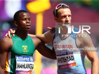 L-R Ntando Mahlangu (RSA), and Richard Whitehead of Great Britain Men's 100m T42 Round 1 Heat 1during IPC World Para Athletics Championships...