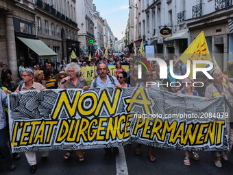 People hold a banner reading no to the permanent state of emergency, during a demonstration against the state of emergency on July 18, 2017,...
