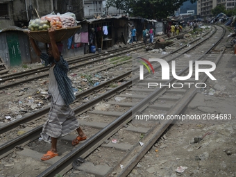 Slum people next to railway tracks at kawranbazar area on July 18, 2017 in Dhaka, Bangladesh. Hundred of low income families come from the c...