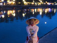 A young woman poses at the mouth of the Thu Bon River in Hoi An (Vietnam) a small town on the coast of the South China Sea
HOIAN-VIETNAM (
