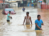 Indian residents wade through flooded area at Dhobinala in Dimapur, India north eastern state of Nagaland on Wednesday, 19 July 2017. Incess...