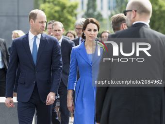 Britain's Prince William, Duke of Cambridge (L) and his wife Kate, the Duchess of Cambridge (C) arrive at the Holocaust Memorial in Berlin o...