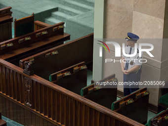 Marshals Guard watch the entrance to the rostrum during a night debate on a Supreme Court bill, in the lower house of Polish Parliament (Sej...