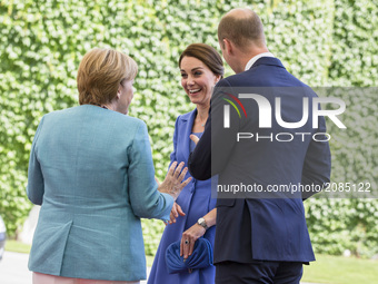 German Chancellor Angela Merkel greets Britain's Prince William, Duke of Cambridge and his wife Kate, the Duchess of Cambridge upon their ar...